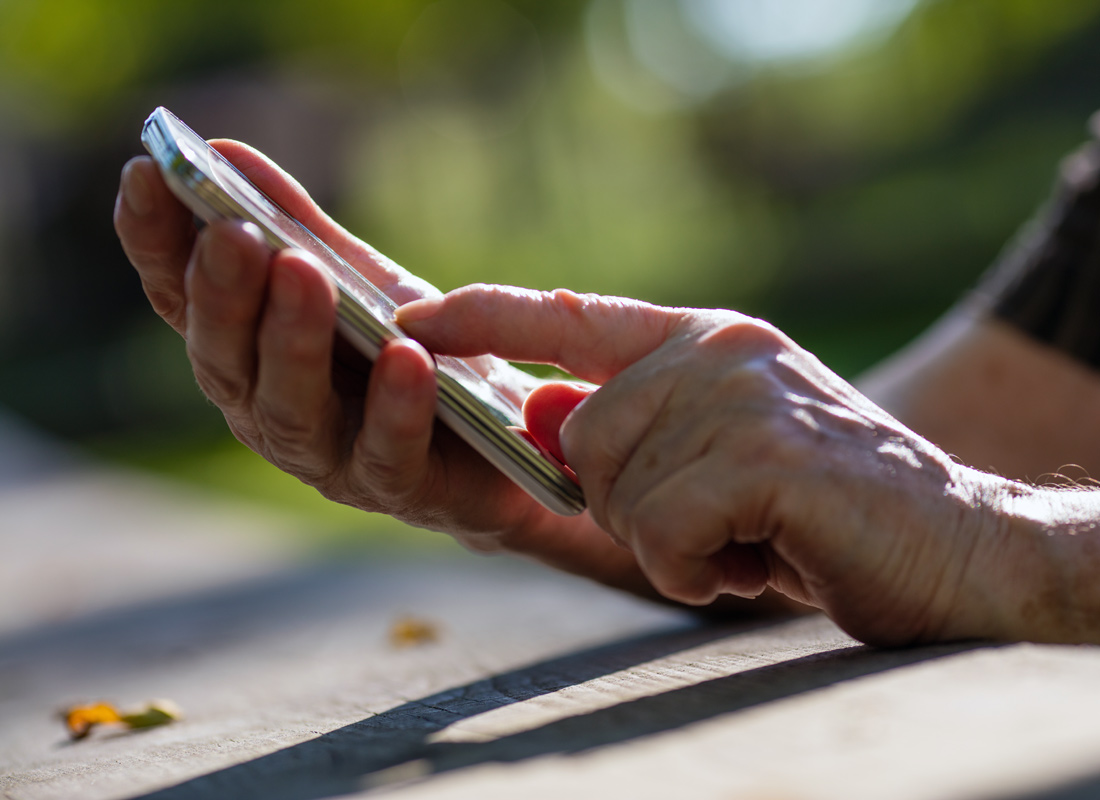 Relaxing in the park and using an app on a smartphone