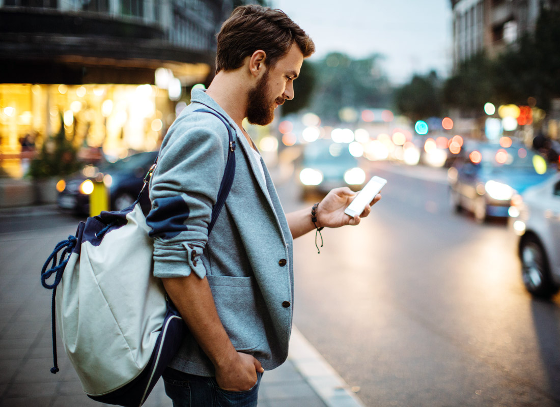 Nearly at his destination, a tourist checks directions using his smartphone map app