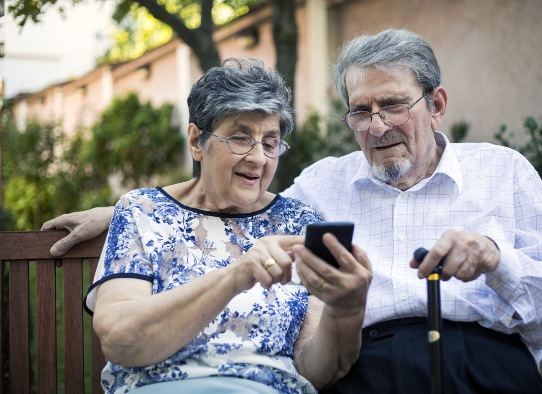 A couple checking the bus timetable using an app on their smartphone