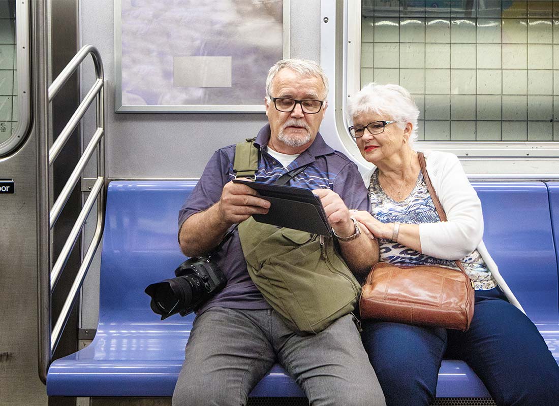 A couple using their device on the New York subway